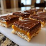 Close-up of layered caramel ritz cracker christmas cookies squares topped with chocolate ganache.