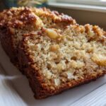 Close-up of a moist slice of Hawaiian banana bread showing the crumb texture and fruit pieces.