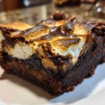 A single, rich slice of hot chocolate brownies topped with toasted, gooey marshmallows.