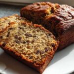 Close-up of sliced mini banana bread loaves showing moist texture and chocolate chips.