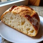 Close-up of the open crumb structure of a freshly baked no knead bread loaf.
