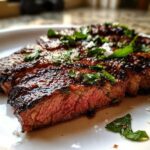 Close-up of sliced, juicy steak showing a medium-rare center, glazed with a rich sauce from the carne asada marinade.
