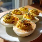 Close-up of Classic Deviled Eggs with Dill Pickle Relish, garnished with paprika and fresh dill.