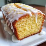 A moist slice of Copycat Starbucks Iced Lemon Loaf drizzled with thick white icing and lemon zest.