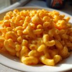 A close-up, mouthwatering serving of creamy Instant Pot Mac and Cheese featuring elbow macaroni coated in bright orange cheese sauce.