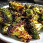 Close-up of perfectly cooked Crispy Parmesan Roasted Broccoli with dark, caramelized edges.