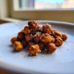 Close-up of a small pile of Crunchy Air Fryer Ranch Chickpeas sprinkled with coarse salt.