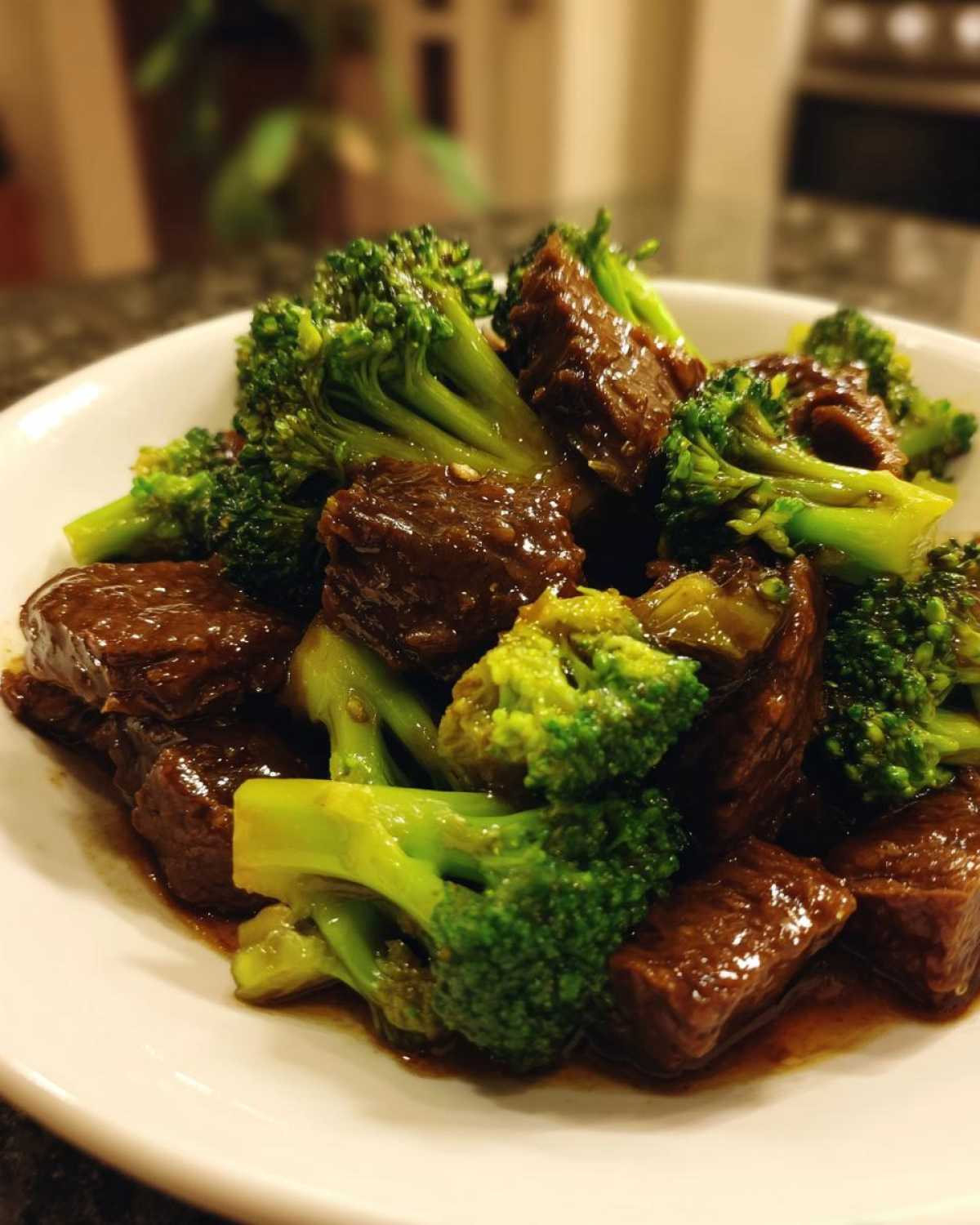 Close-up of tender chunks of beef coated in savory sauce mixed with bright green broccoli florets, ready to eat Instant Pot Beef and Broccoli.