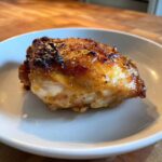 Close-up of a perfectly cooked Lemon Garlic Roasted Chicken Thighs with crispy, caramelized skin.