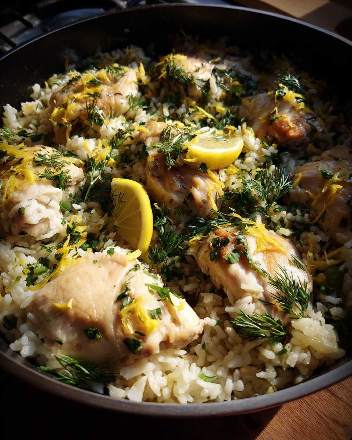Close-up of One-Pot Chicken and Rice with Lemon and Herbs garnished with fresh dill and lemon zest.