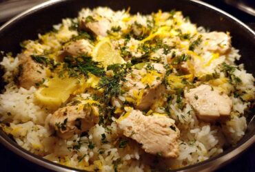 Close-up of One-Pot Chicken and Rice with Lemon and Herbs, topped with fresh dill and lemon zest.