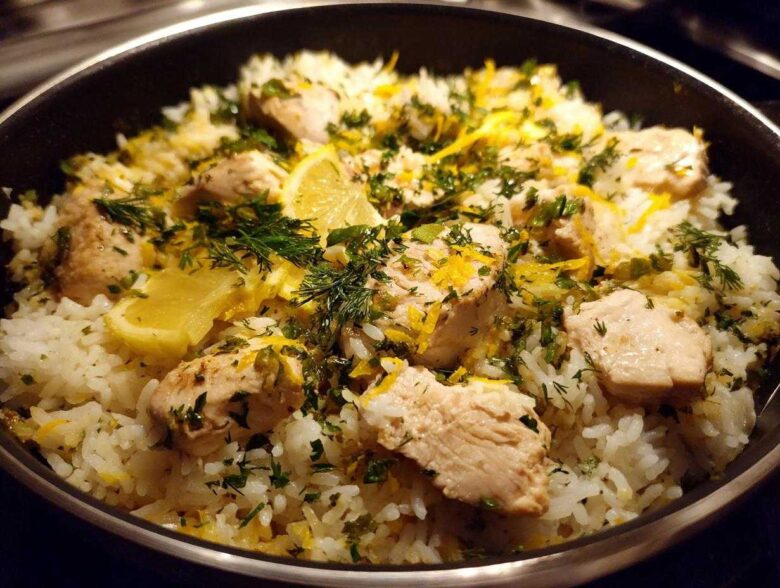 Close-up of One-Pot Chicken and Rice with Lemon and Herbs, topped with fresh dill and lemon zest.