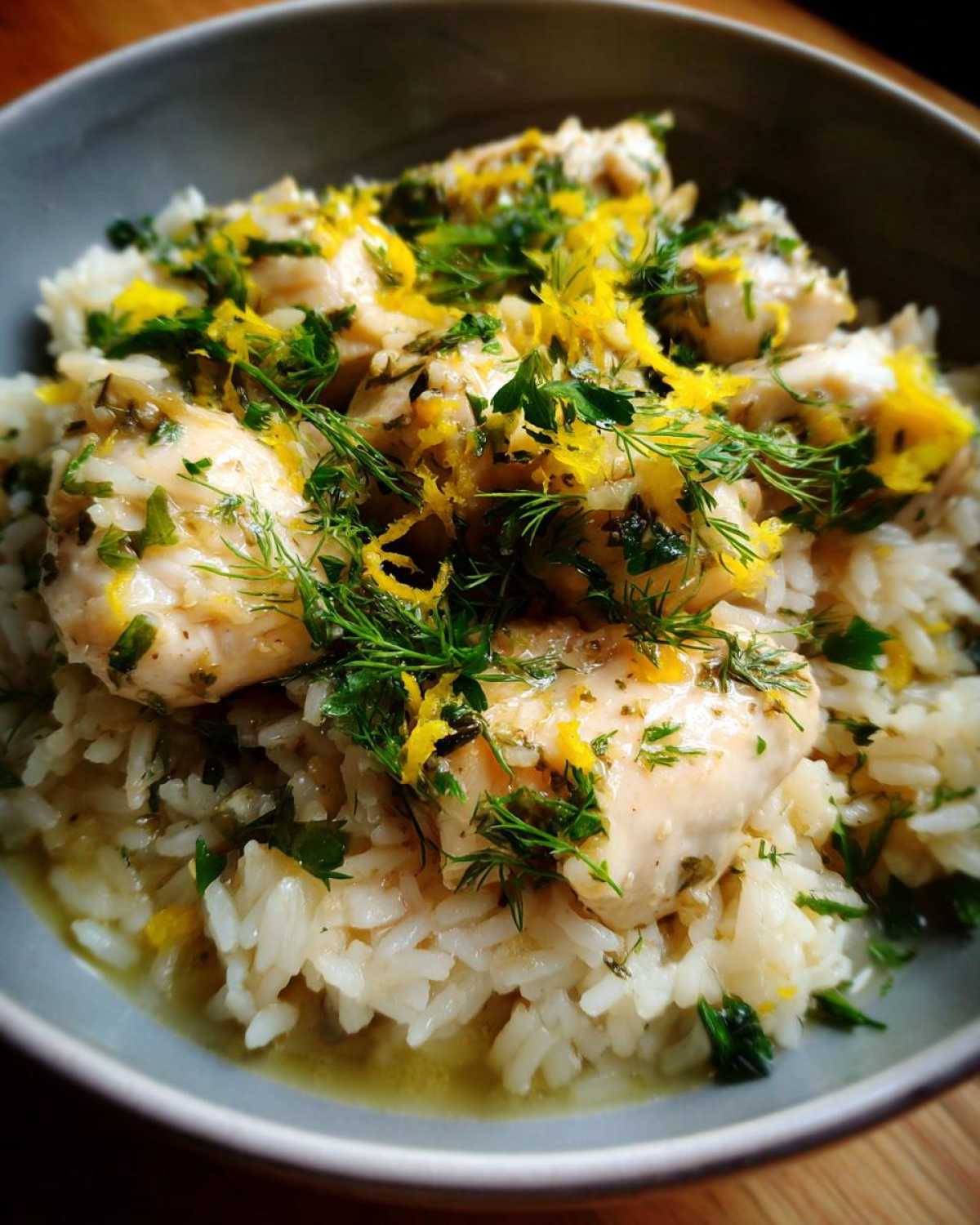 Close-up of One-Pot Chicken and Rice with Lemon and Herbs topped with fresh dill and zest.