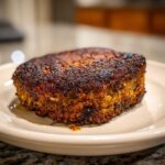 Close-up of a thick, perfectly seared Smoky Black Bean Burger Patty with a dark, crusty exterior.