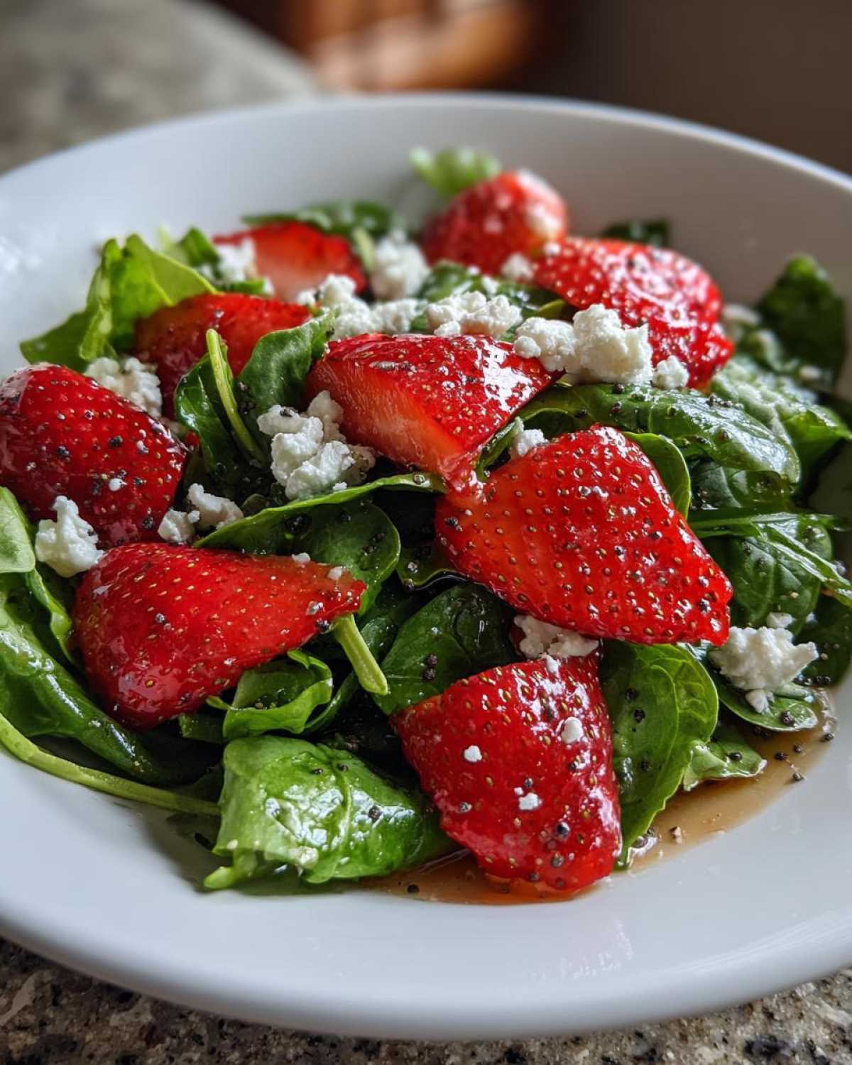 Close-up of a vibrant Spring Mix Salad with Strawberries and Goat Cheese, tossed in a light vinaigrette.