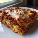 A generous slice of Cheesy Baked Ziti with Ground Beef and Sauce, featuring layers of pasta, meat sauce, and melted cheese.