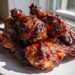 A pile of oven baked Crispy Honey Garlic Chicken Drumsticks with a shiny, caramelized glaze.