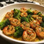 Close-up of Garlic Butter Shrimp and Broccoli Skillet, featuring plump shrimp coated in herbs and butter sauce with bright green broccoli florets.