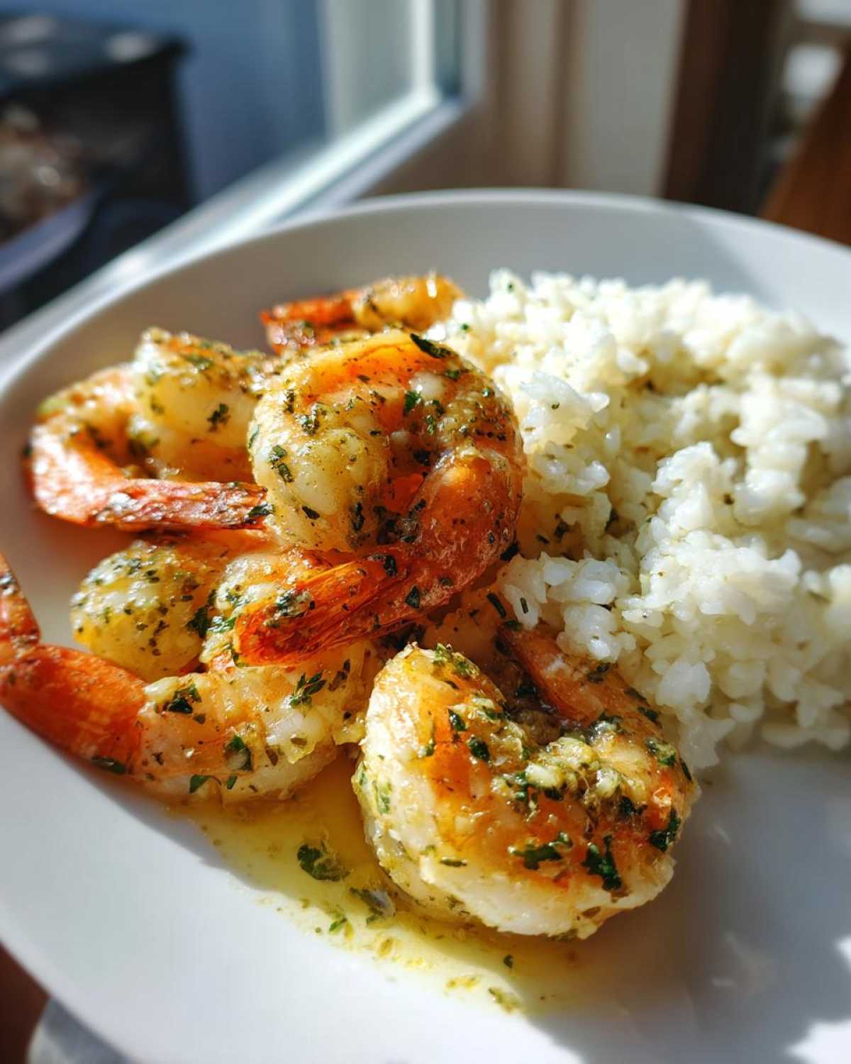 Close-up of juicy Garlic Butter Shrimp and Rice Easy Recipe served on a white plate.