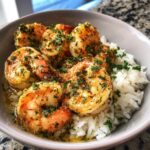 Close-up of a Garlic Butter Shrimp Bowl with Rice, topped with fresh parsley.