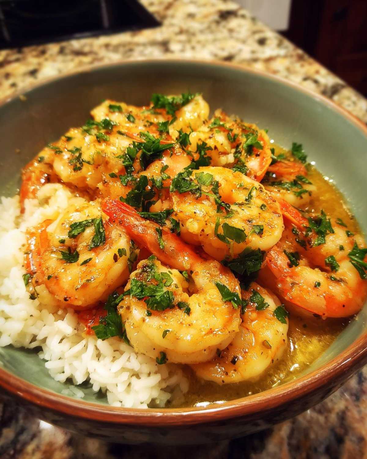 Close-up of a Garlic Butter Shrimp Bowl with Rice, topped with fresh parsley.
