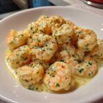 Close-up of plump shrimp coated in a rich, creamy Parmesan sauce, garnished with fresh parsley for Garlic Butter Shrimp.