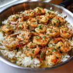 Close-up of juicy Garlic Butter Shrimp with Rice Skillet, topped with parsley.