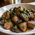 Close-up of tender Garlic Butter Steak Bites with Mushrooms, glistening with sauce and topped with fresh parsley.