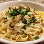 Close-up of Honey Garlic Chicken Pasta with Cream Sauce, featuring fettuccine noodles and garnished with fresh parsley.