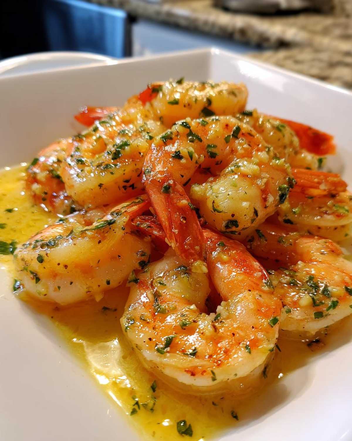 Close-up of succulent shrimp coated in a rich lemon butter sauce with visible garlic and parsley, showcasing the Lemon Butter Shrimp with Garlic Flavor.