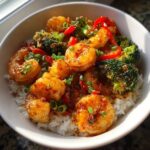 Close-up of a Spicy Honey Garlic Shrimp with Rice Bowl, featuring glazed shrimp, broccoli, and red peppers.