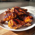 A pile of perfectly cooked Sticky Honey Garlic Chicken Drumsticks Crispy, glazed with a dark, shiny sauce.