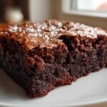 Close-up of a fudgy square of Brown Butter Brownies topped with flaky sea salt.