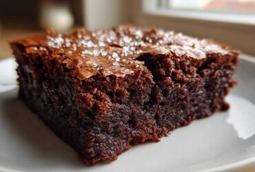 Close-up of a fudgy square of Brown Butter Brownies topped with flaky sea salt.
