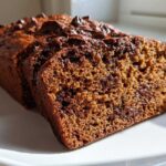 Close-up of sliced Sourdough Chocolate Chip Quick Bread showing moist crumb and melted chocolate chips.