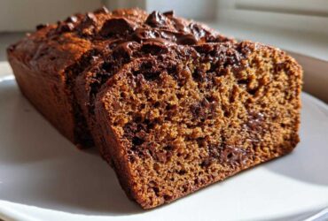 Close-up of sliced Sourdough Chocolate Chip Quick Bread showing moist crumb and melted chocolate chips.